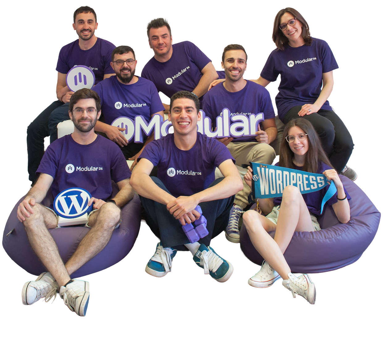 The Modular DS team wearing purple Modular DS t-shirts, sitting together and smiling.